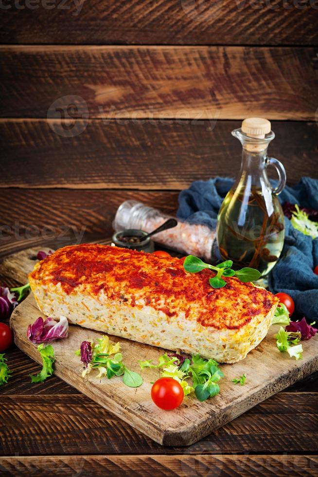 American meatloaf with chicken meat, pumpkin and green peas. Baked minced chicken meat photo