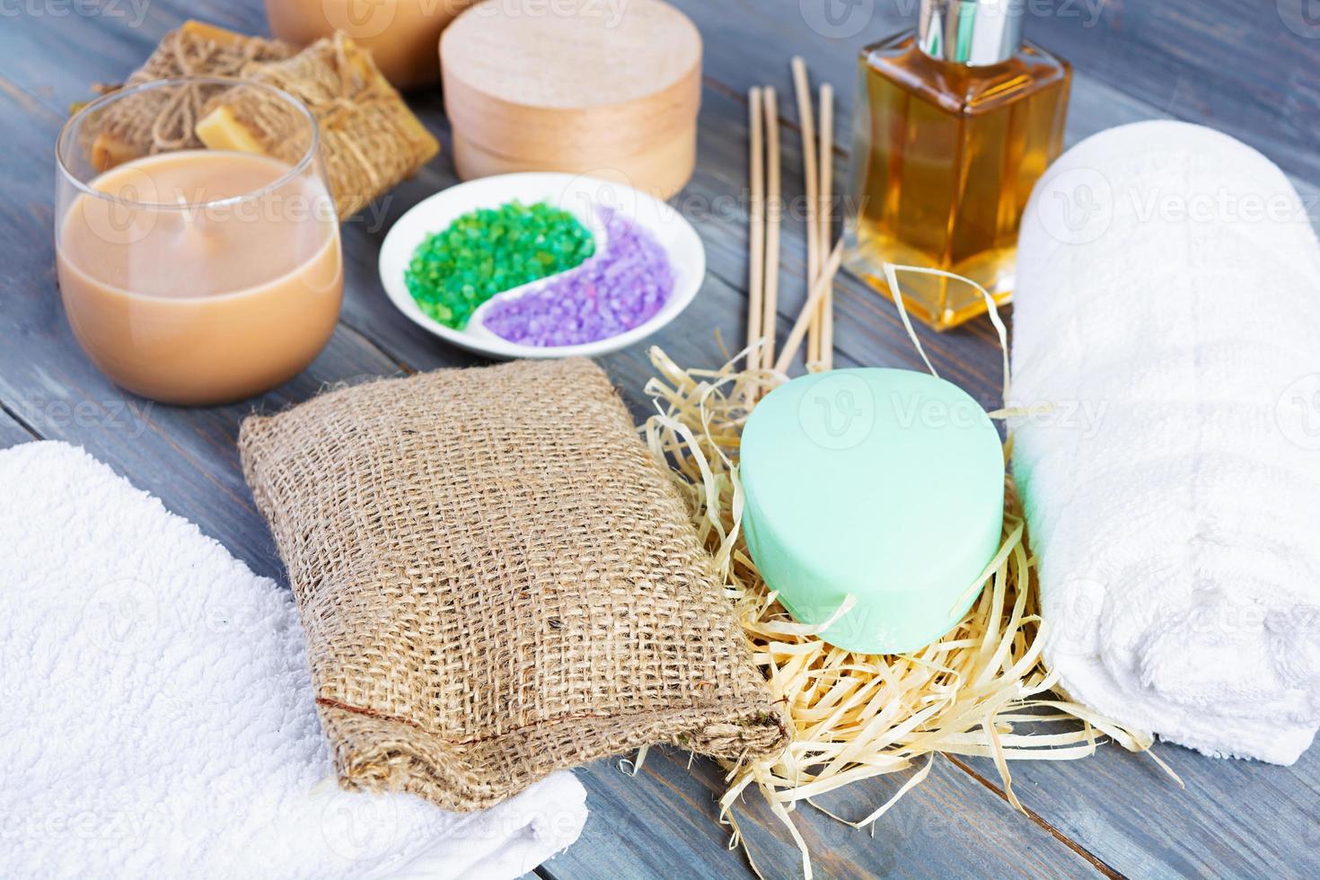 Different spa and bathroom products isolated on wooden background. Products for beauty treatments and body care photo