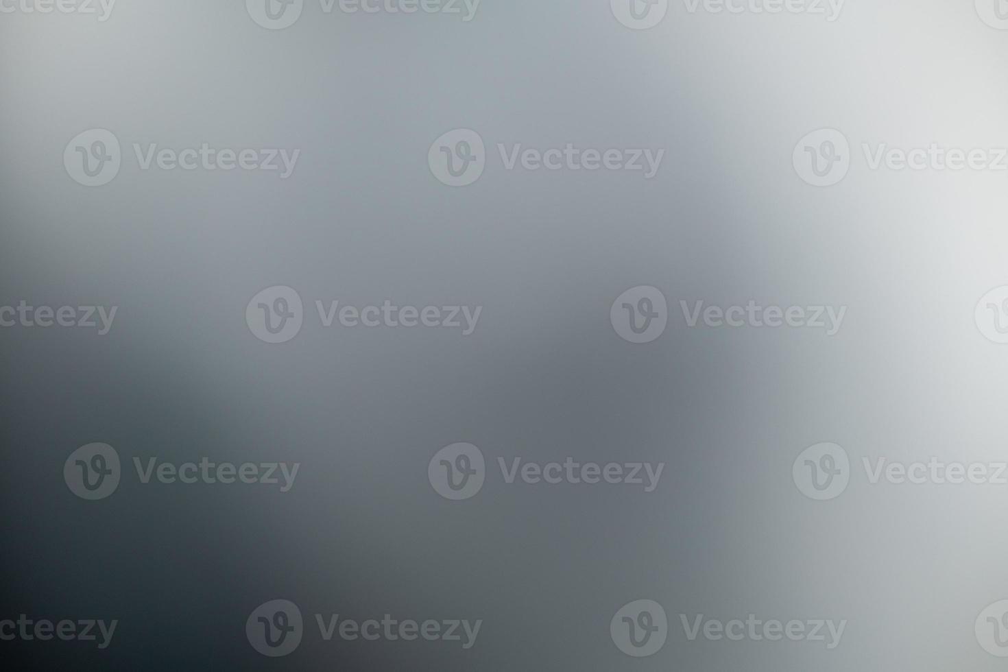 Dark black and gray blurred  gradient background has a little abstract light. photo