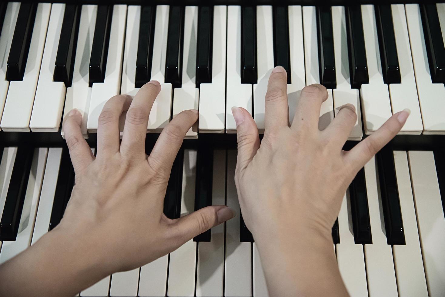 Woman hand play electone keyboard - people with music concept photo