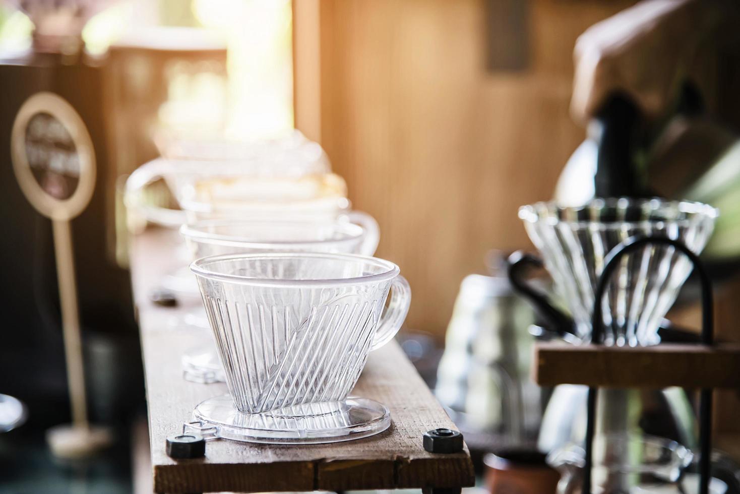 Man making drip fresh coffee in vintage coffee shop with green nature background - people with fresh coffee in nature concept photo