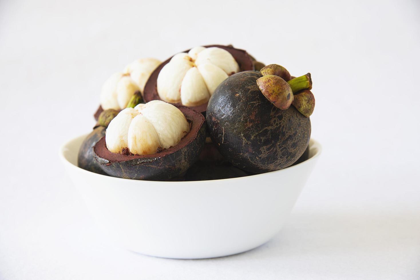 Mangosteen Thai popular fruits - a tropical fruit with sweet juicy white segments of flesh inside a thick reddish-brown rind. photo