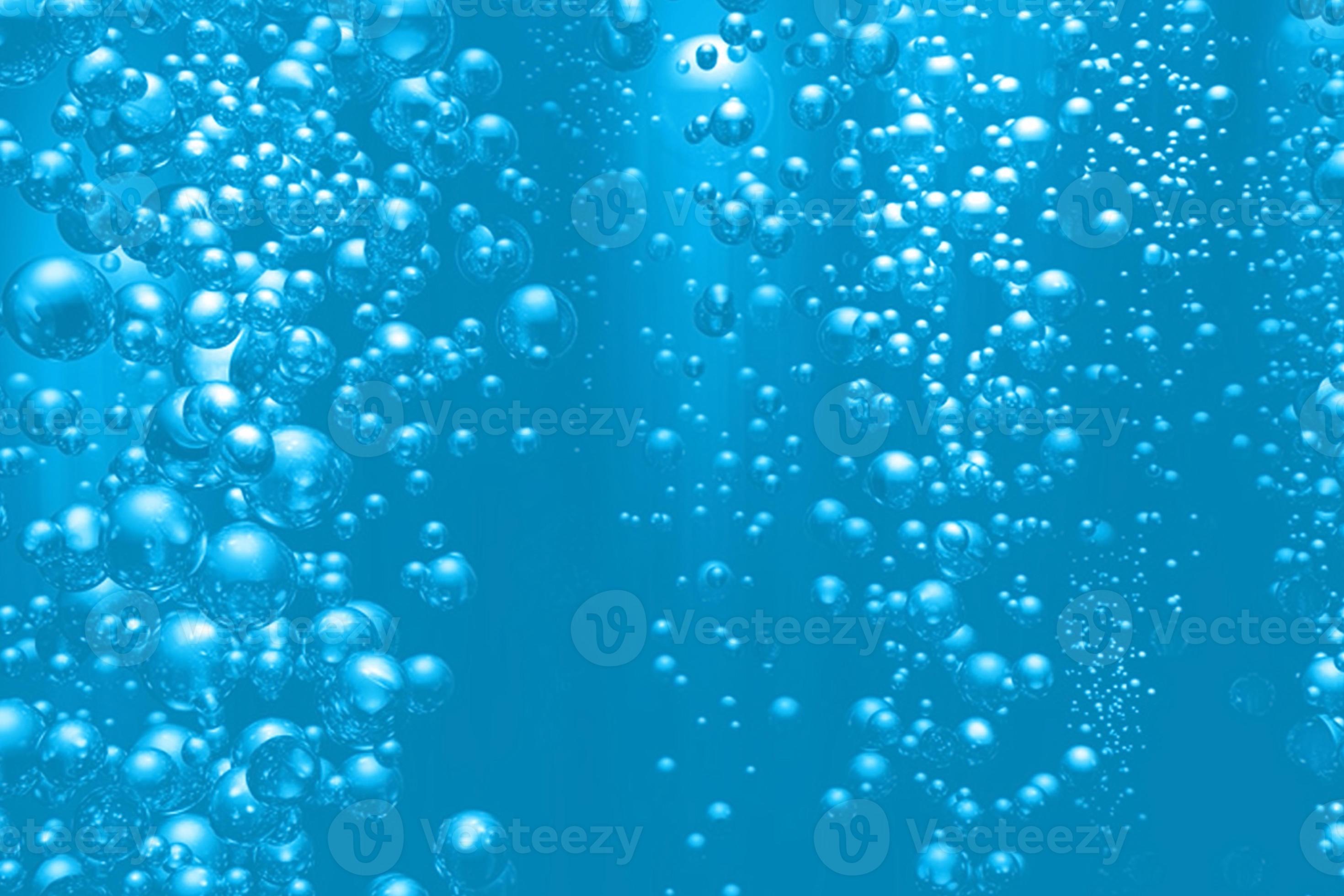 Defocus blurred transparent blue colored clear calm water surface