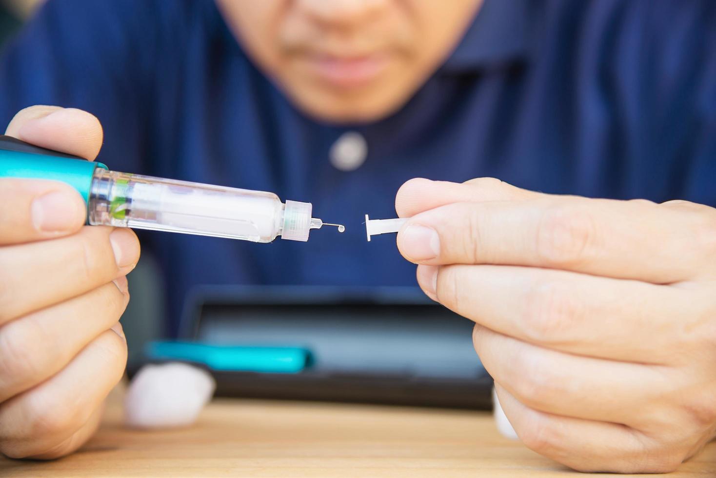 Man preparing insulin diabetic syringe for injection - people diabetic health care concept photo