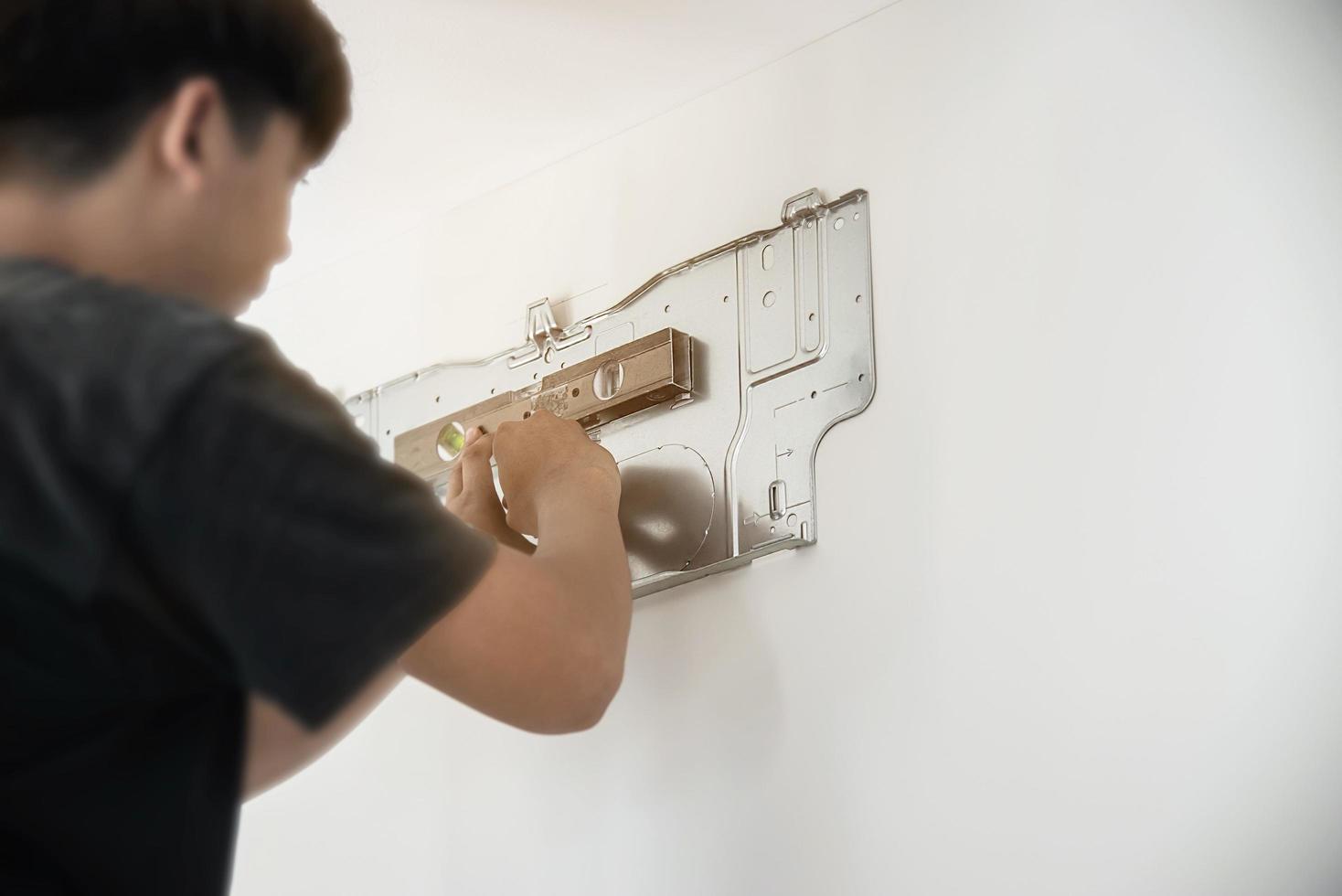 Technician is installing air conditioner during hot season photo