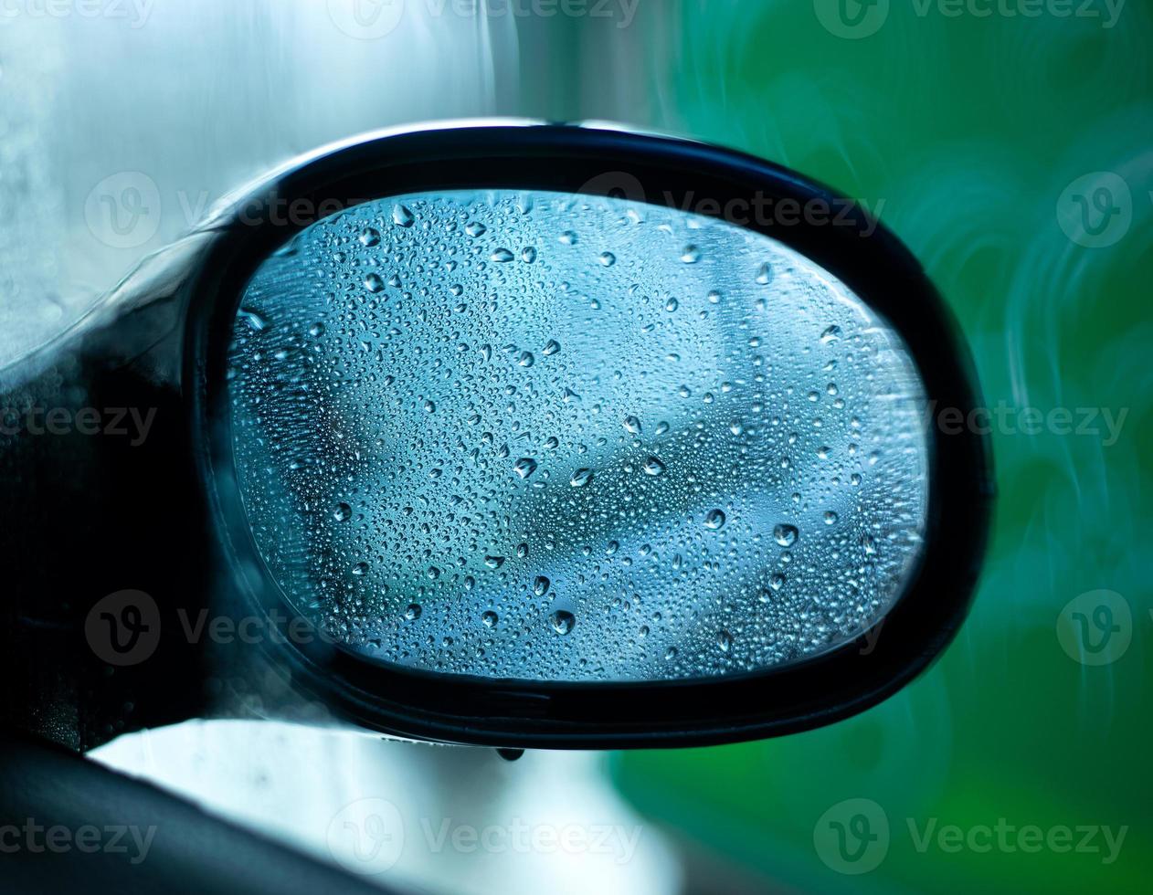 Car side view mirror with rain drops photo