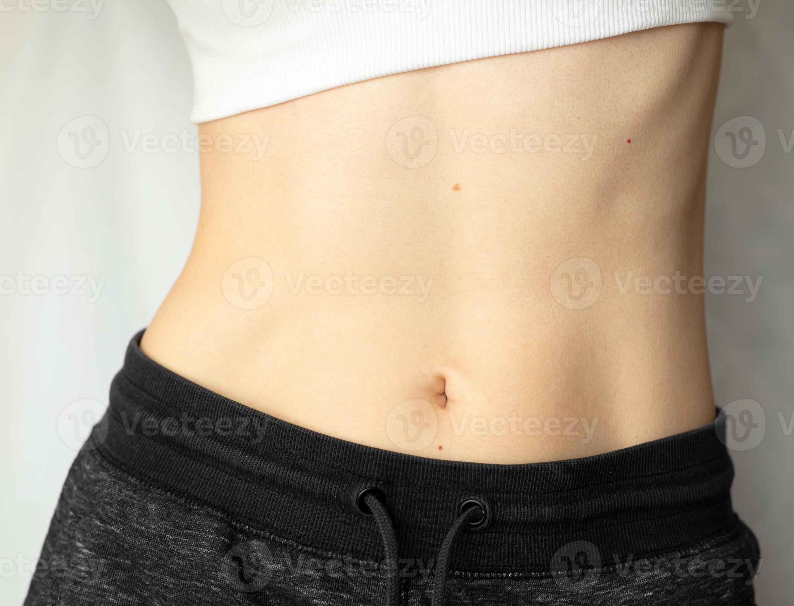 A Woman Shows Her Flat Stomach Athletic Belly Of A Young Girl 10247751