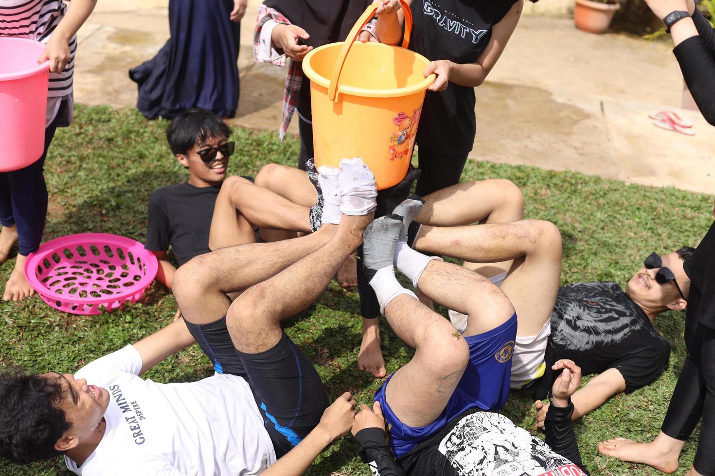 Sumedang, Indonesia July 2022 The excitement of young Asian people are doing outbound activities or playing games in the grass. This outbound activity aims to refresh. photo