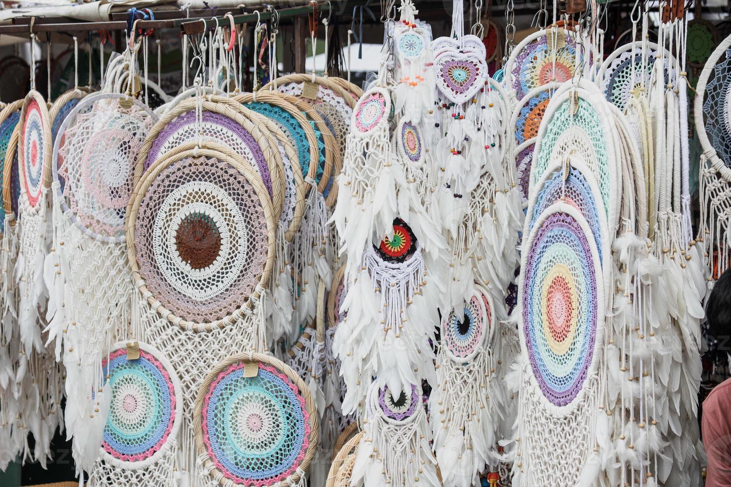 Various handcrafted white multi-colored dreamcatchers are sell in the market. photo