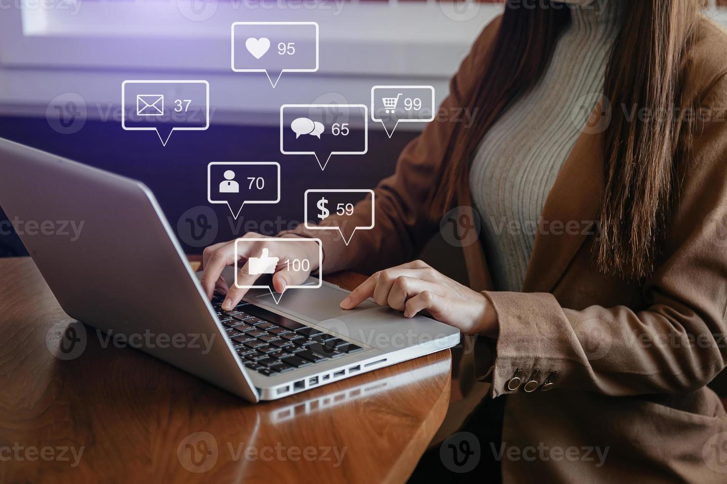 Social media and Marketing virtual icons screen concept.close up of businesswoman typing laptop computer photo