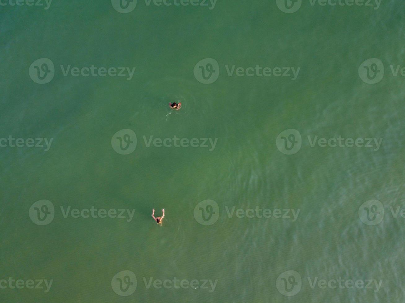 High Angle Footage and Aerial view of Ocean with High Speed Boats, People are having fun and enjoying hottest weather at Bournemouth Beach Sea Front of England UK. photo