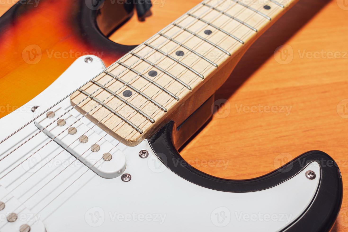 Close-up of a guitar neck and strings with body photo