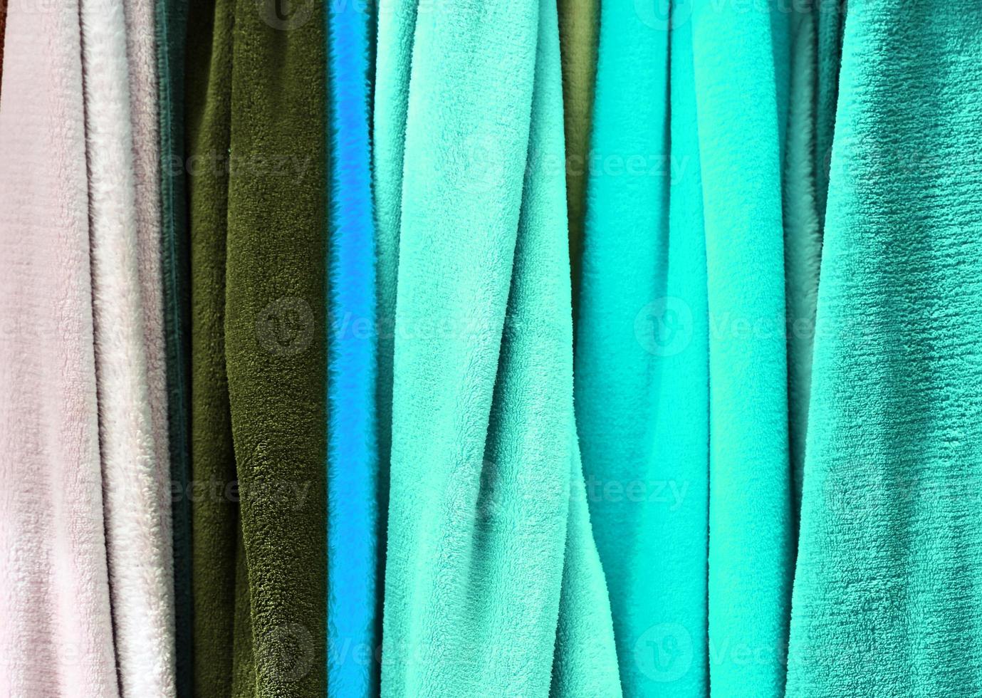 Detailed close up view on samples of cloth and fabrics in different colors found at a fabrics market photo