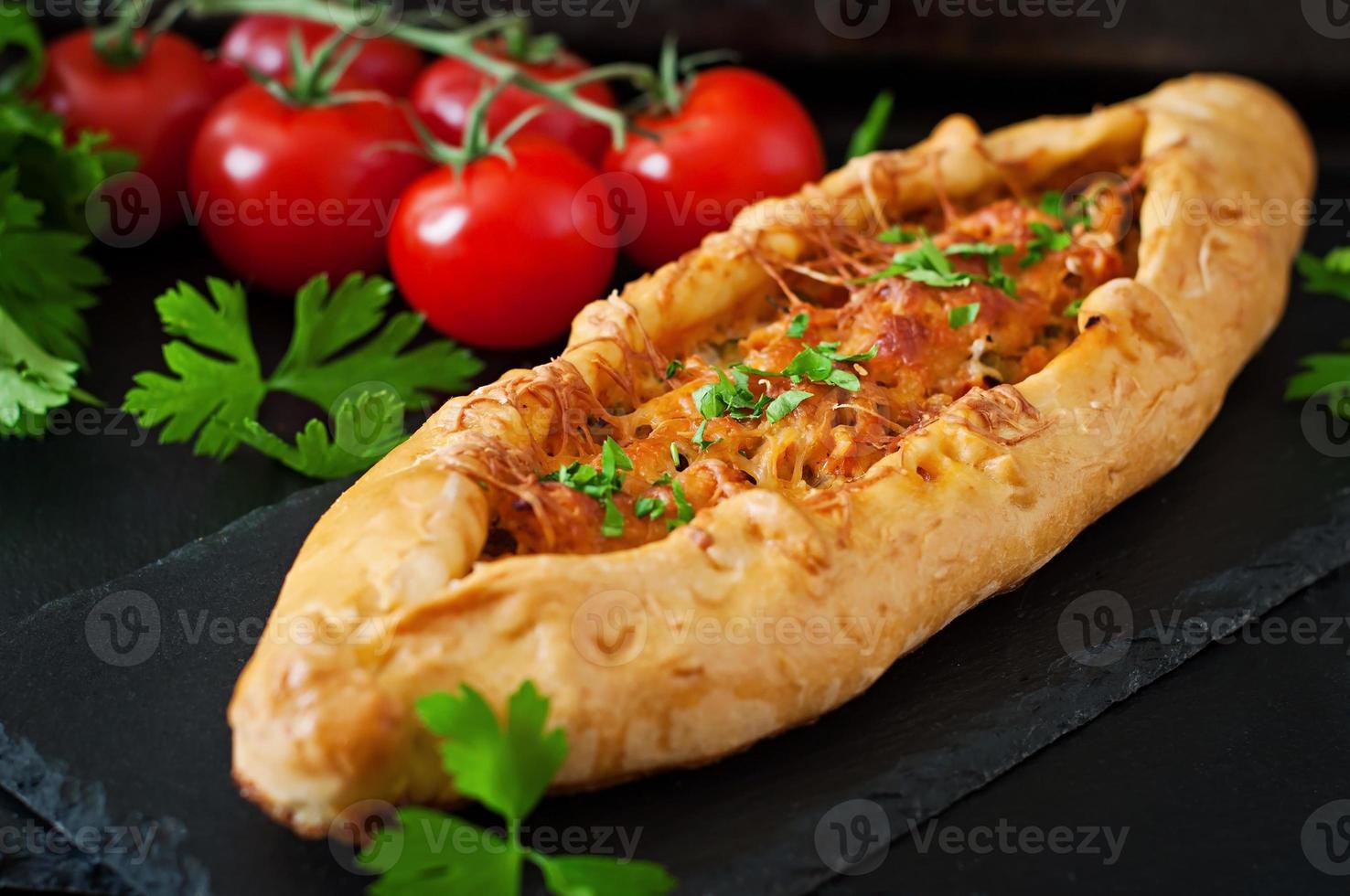 Turkish pide traditional food with beef and vegetables photo