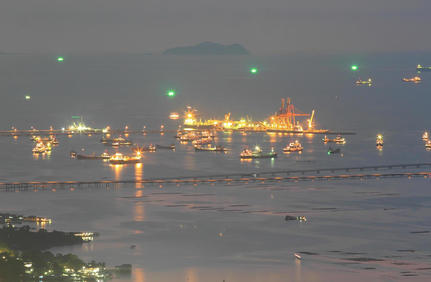 Port warehouse with cargoes and containers at night photo