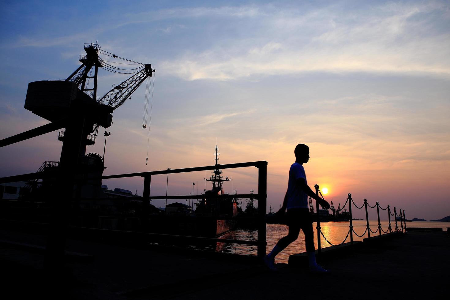 Cranes in dockside at sunset photo