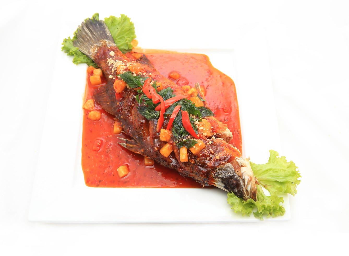 Fried snapper with chili sauce on the plate photo