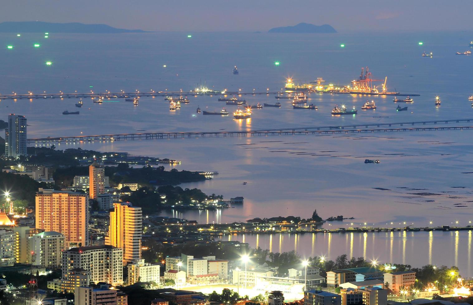 Port warehouse with cargoes and containers at night photo