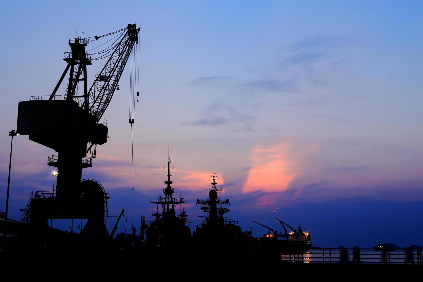 Cranes in dockside at sunset photo