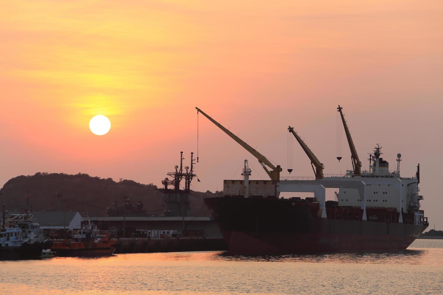 Cargo ship in the harbor at sunset photo