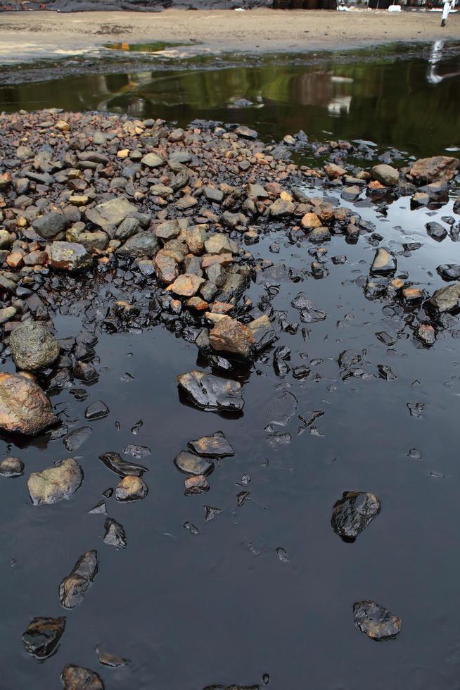 Oil spill on the sea shore photo