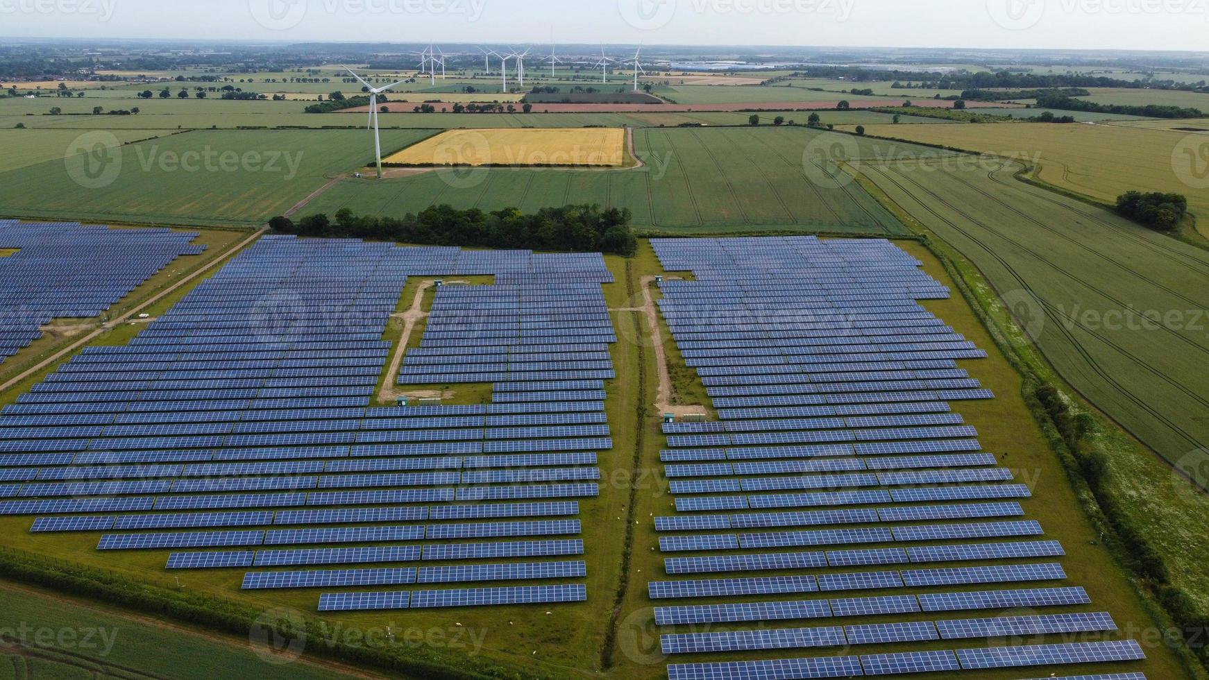 Aerial footage High Angle view of Green Energy natural Generators Sources of Wind turbines and solar panels Farms at England UK photo