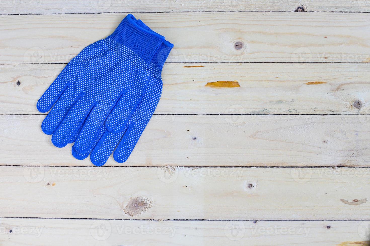 Blue gloves on wooden background photo