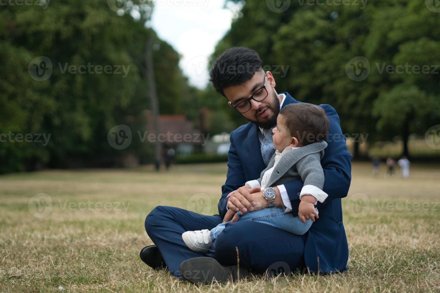 Asian Pakistani Father is holding his 11 Months Old Infant at Local Park photo