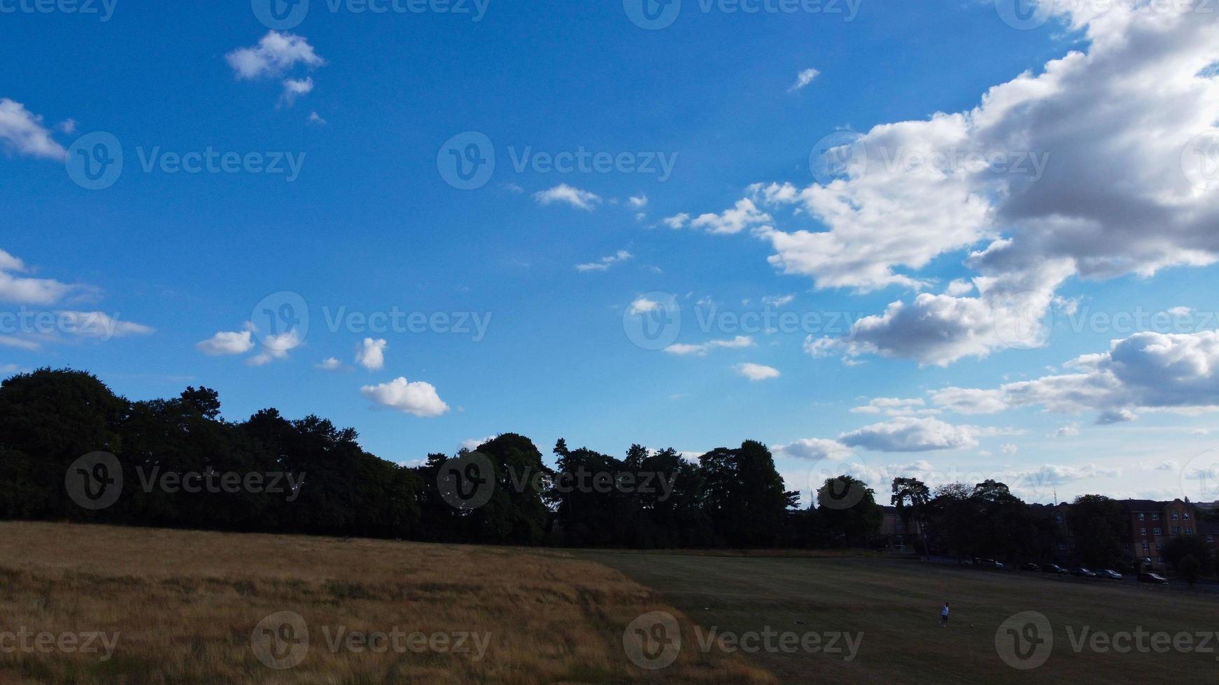 Blue Clear Sky and Few Clouds over England on Hot Summer Day photo