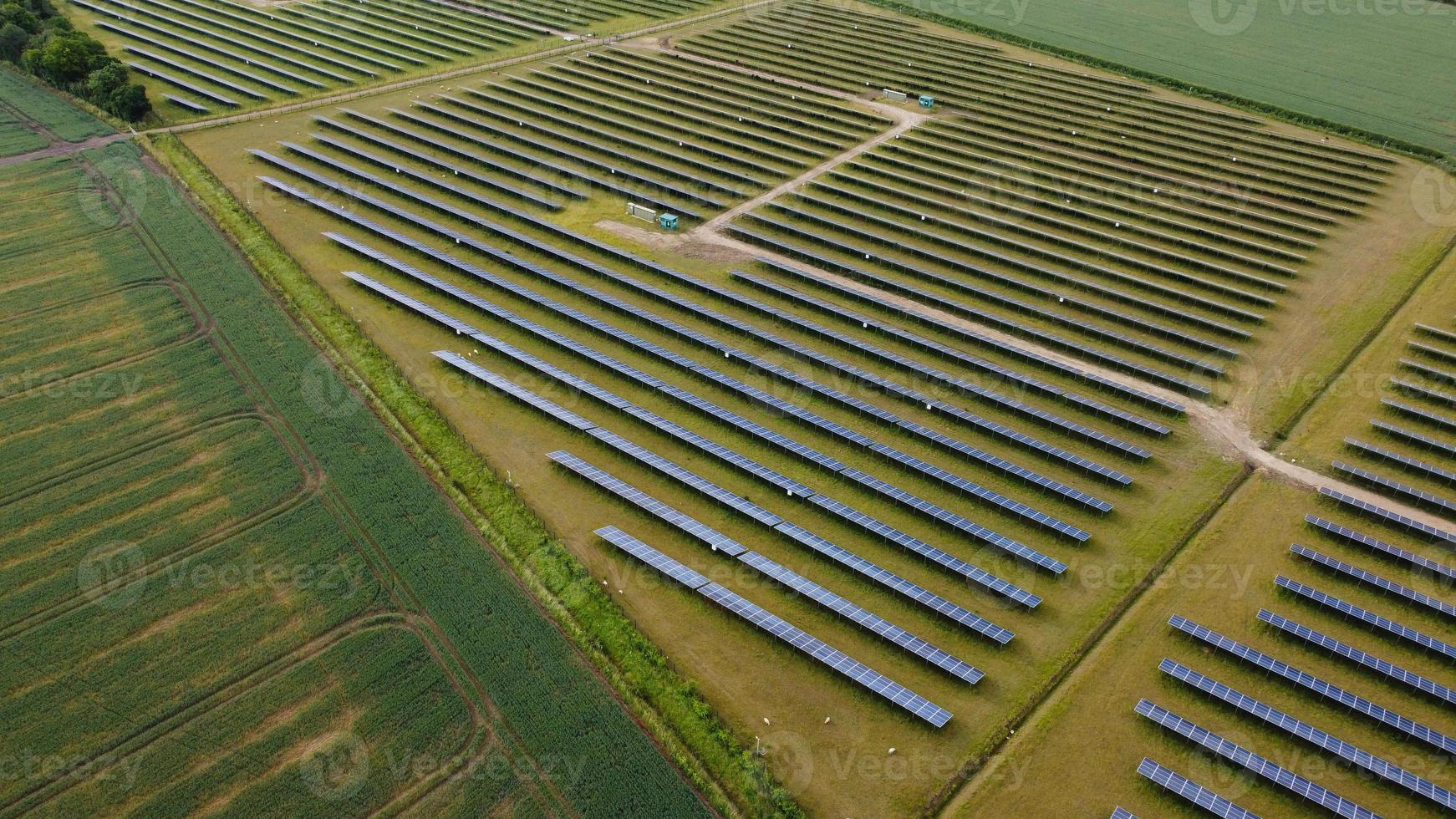 Aerial footage High Angle view of Green Energy natural Generators Sources of Wind turbines and solar panels Farms at England UK photo