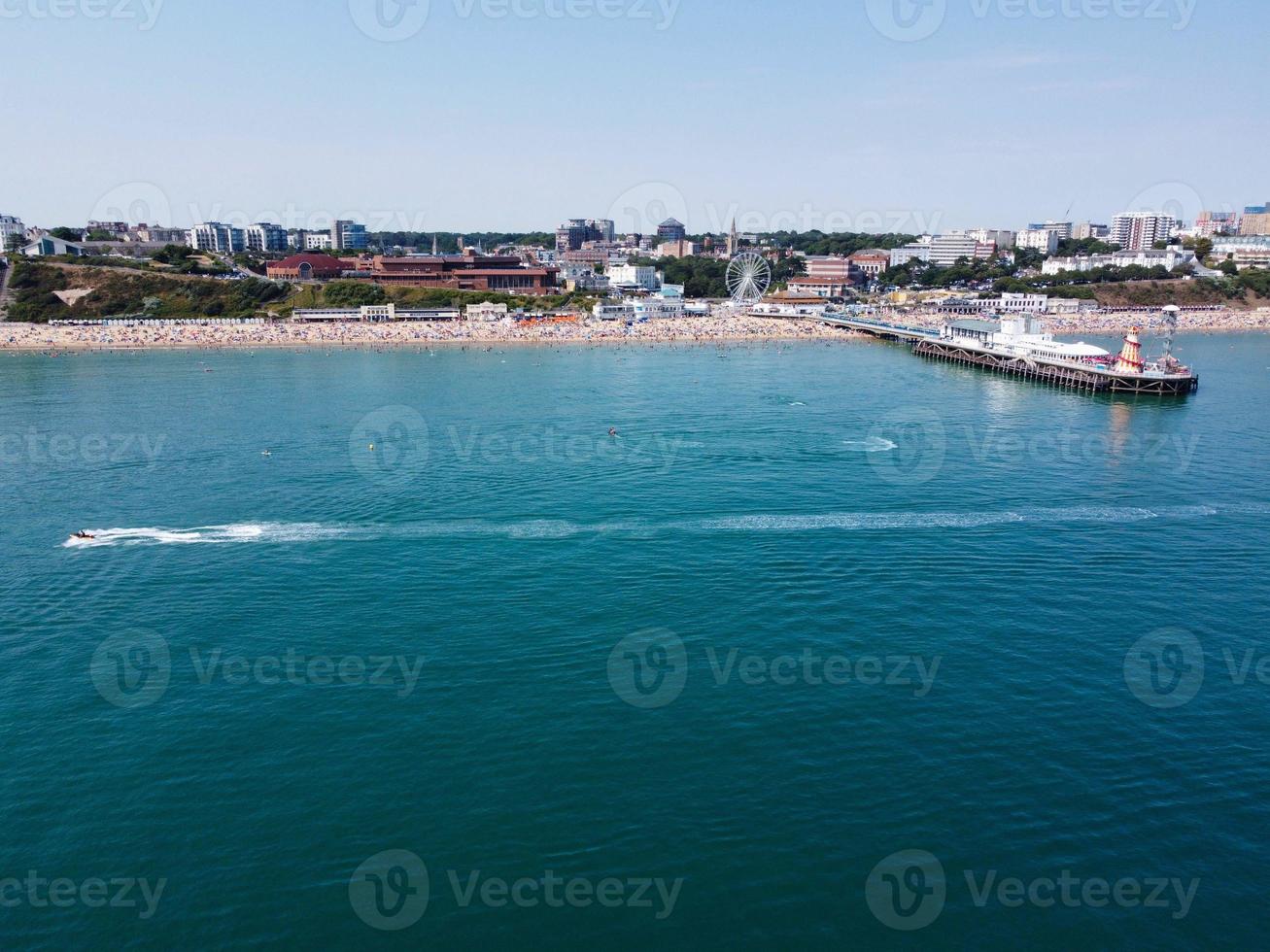 High Angle Footage and Aerial view of Ocean with High Speed Boats, People are having fun and enjoying hottest weather at Bournemouth Beach Sea Front of England UK. photo