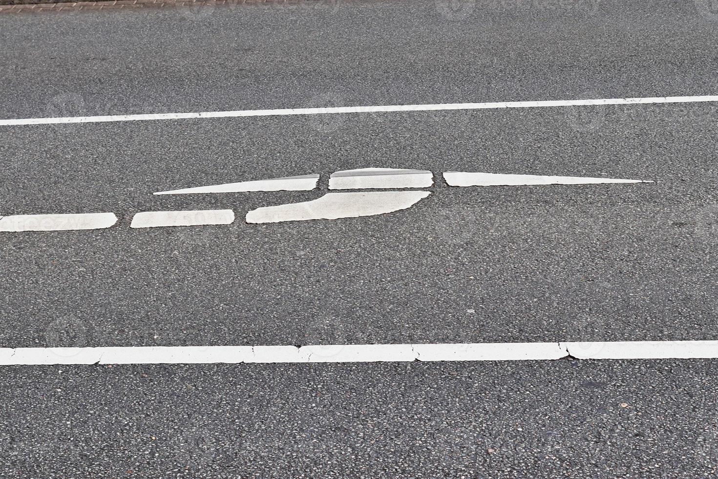 Different signs and marking painted on the ashpalt of streets and roads. photo