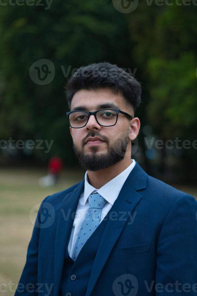 Young Businessman is posing at local park of Luton England UK photo