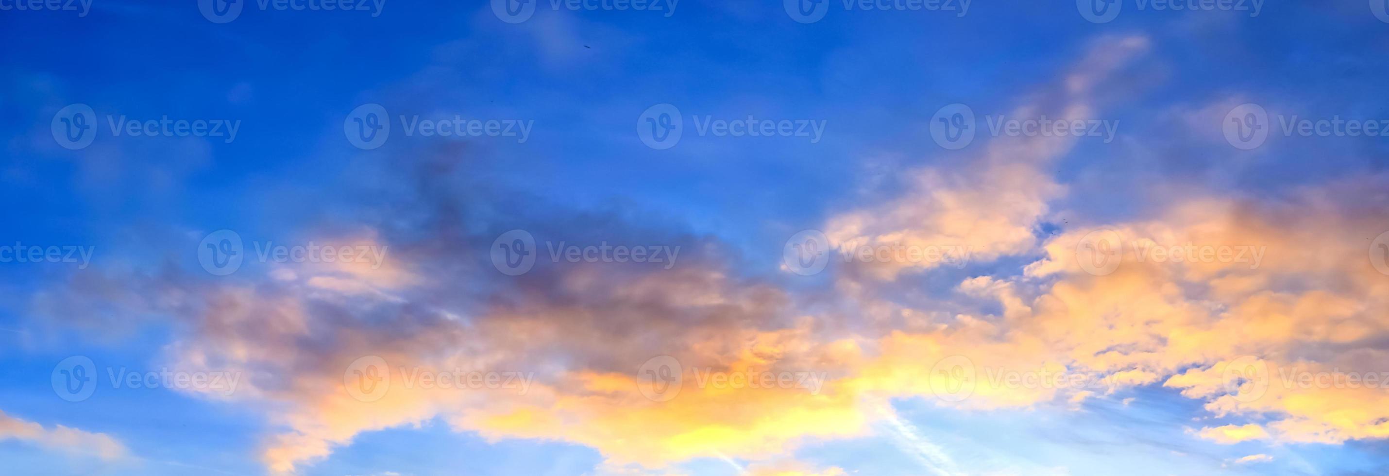 Beautiful high resolution panorama of orange and red sunset clouds in the evening sky photo