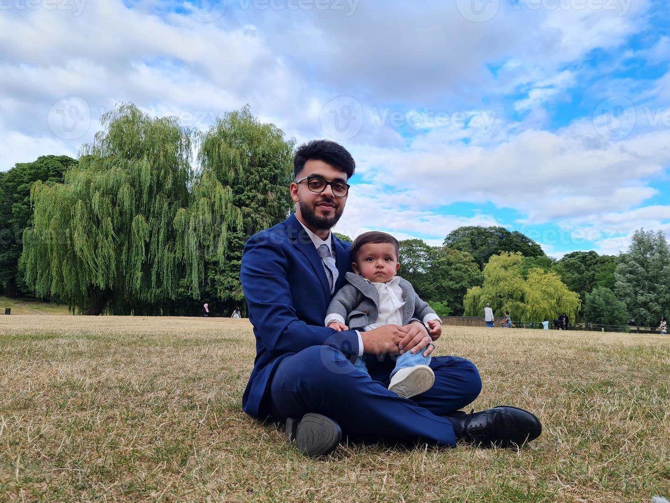 Asian Pakistani Father is holding his 11 Months Old Infant at Local Park photo