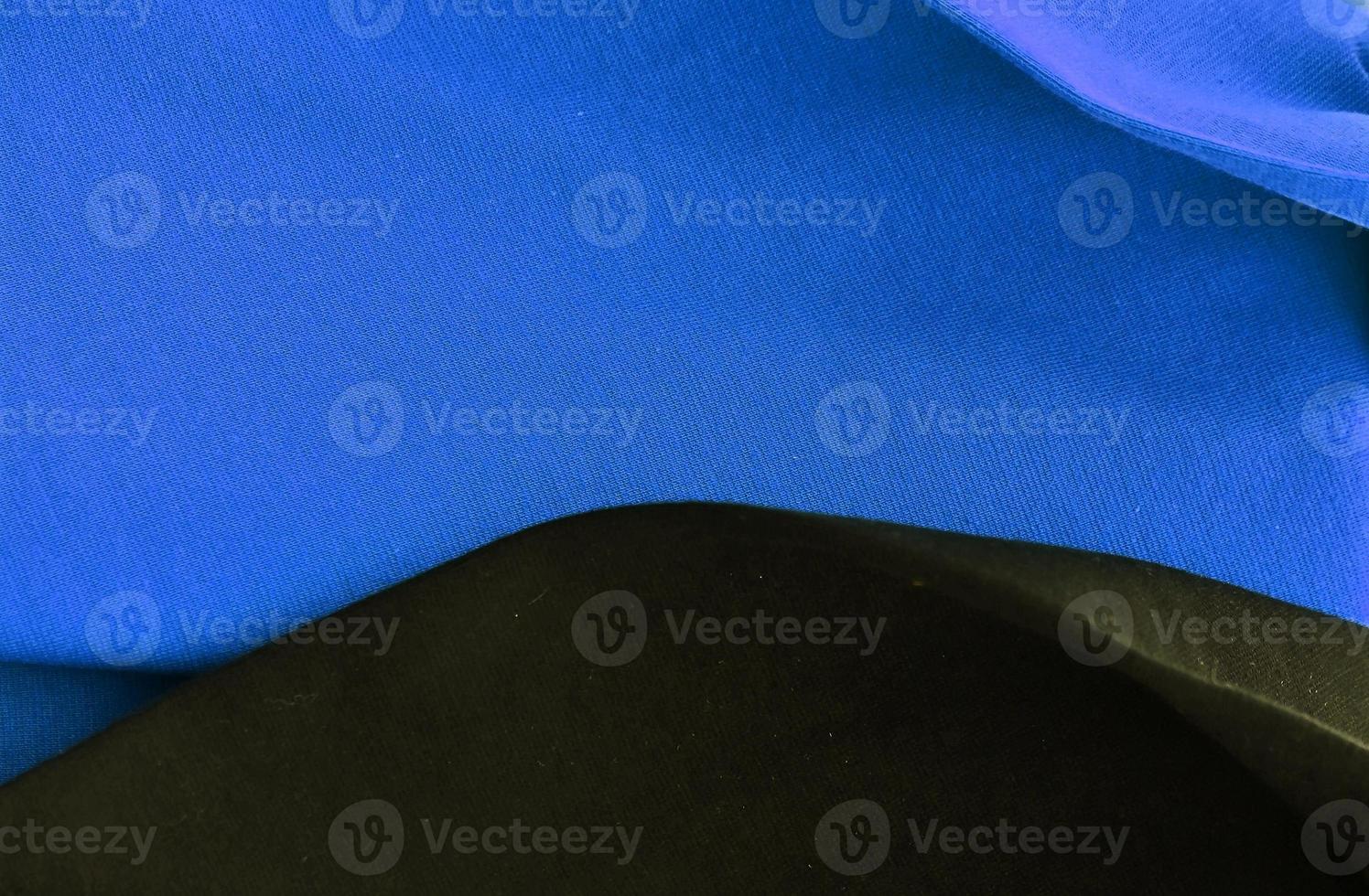 Detailed close up view on samples of cloth and fabrics in different colors found at a fabrics market photo