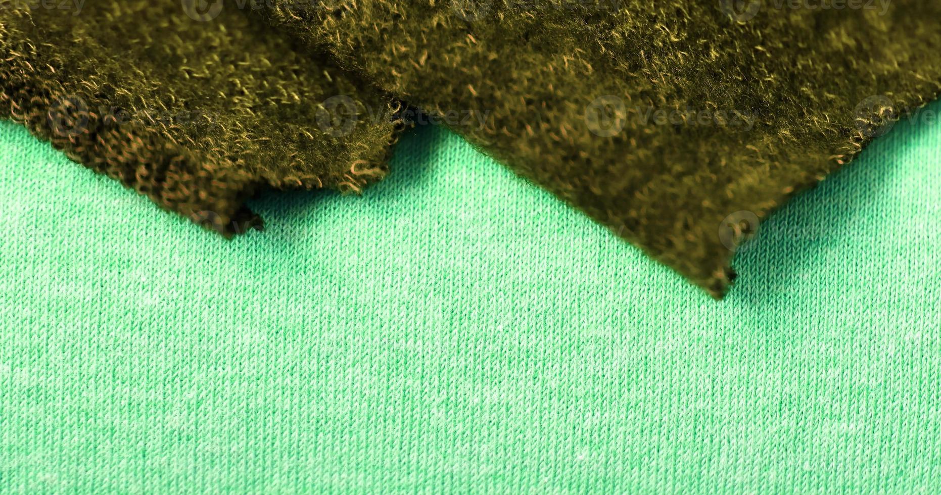 Detailed close up view on samples of cloth and fabrics in different colors found at a fabrics market photo