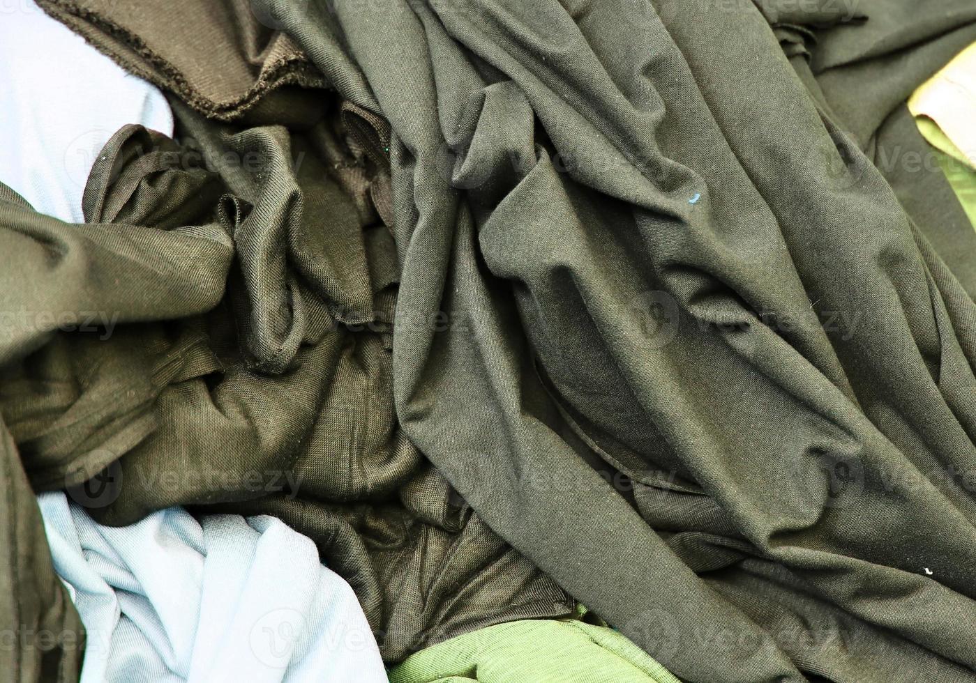 Detailed close up view on samples of cloth and fabrics in different colors found at a fabrics market photo