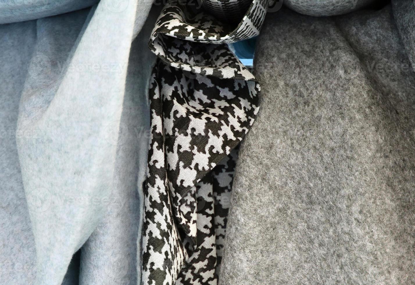 Detailed close up view on samples of cloth and fabrics in different colors found at a fabrics market photo