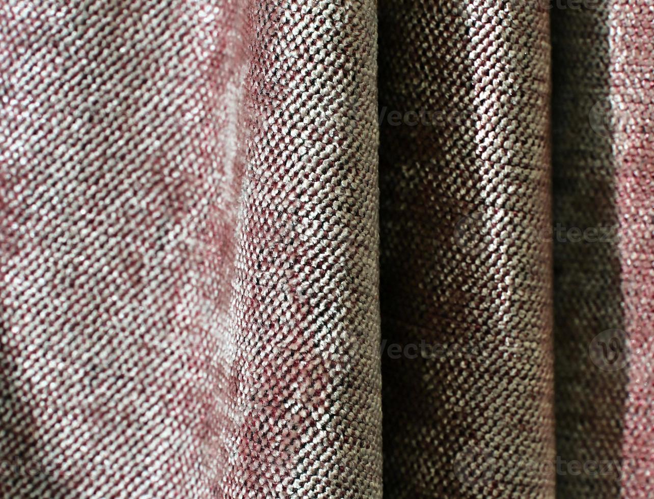 Detailed close up view on samples of cloth and fabrics in different colors found at a fabrics market photo