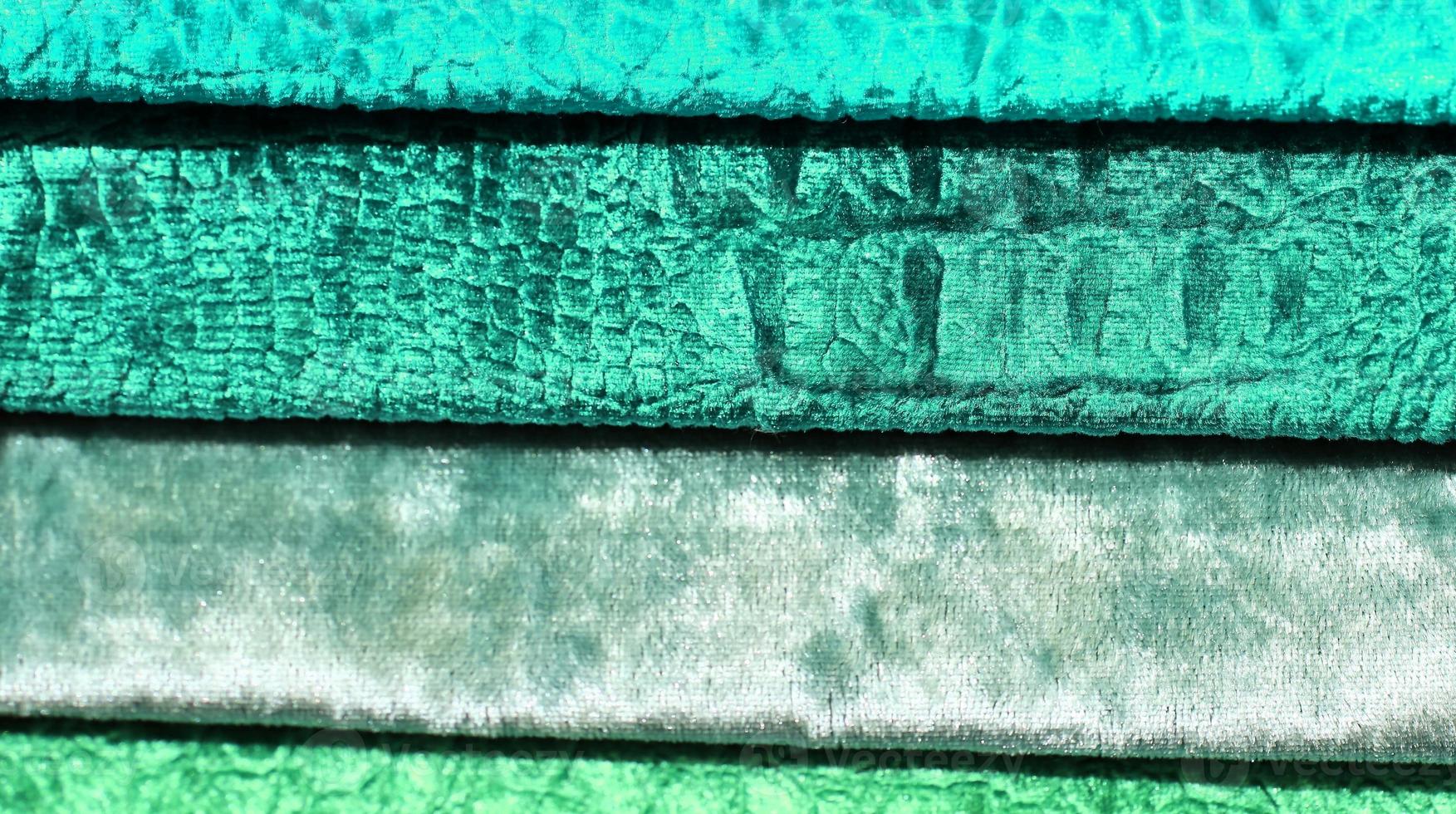 Detailed close up view on samples of cloth and fabrics in different colors found at a fabrics market photo