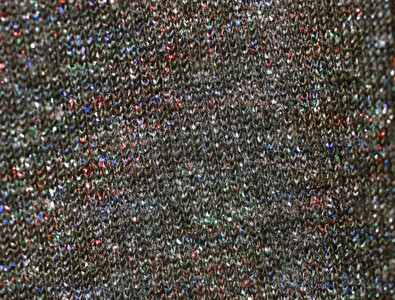 Detailed close up view on samples of cloth and fabrics in different colors found at a fabrics market photo