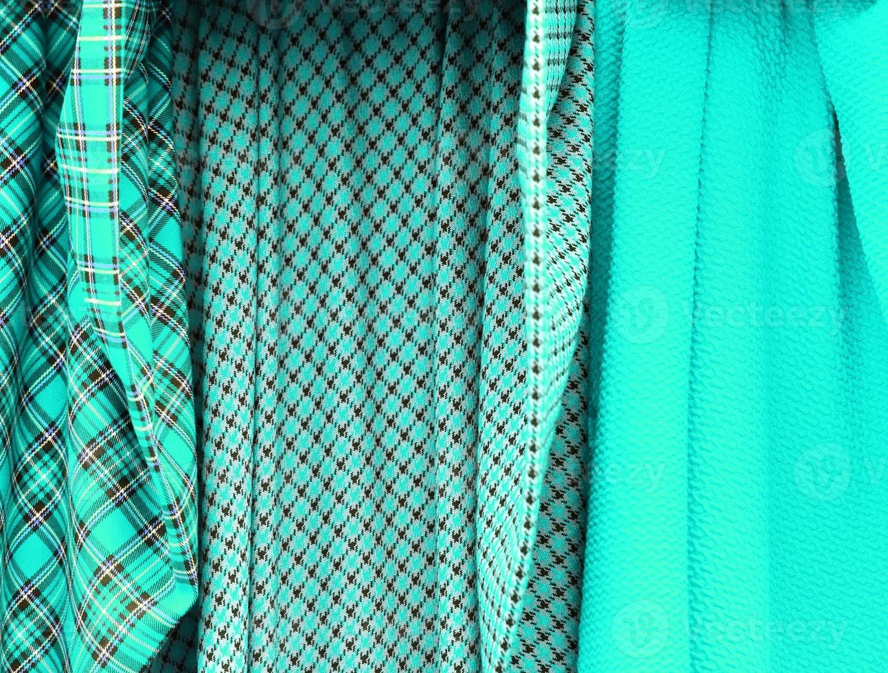 Detailed close up view on samples of cloth and fabrics in different colors found at a fabrics market photo