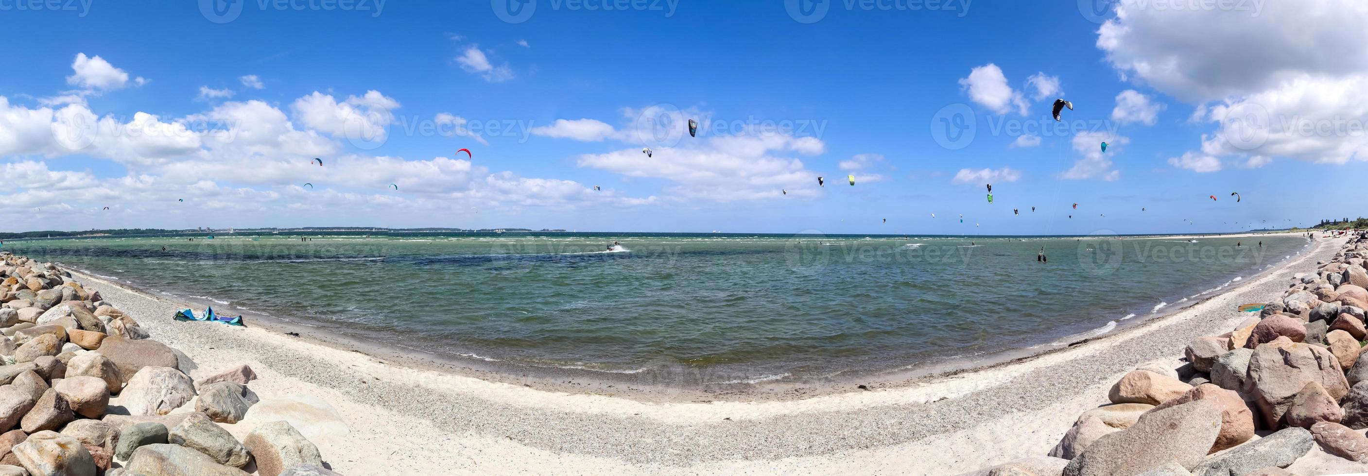 Panorama of kite surfing activity at the Baltic Sea beach of Laboe in Germany on a sunny day. photo