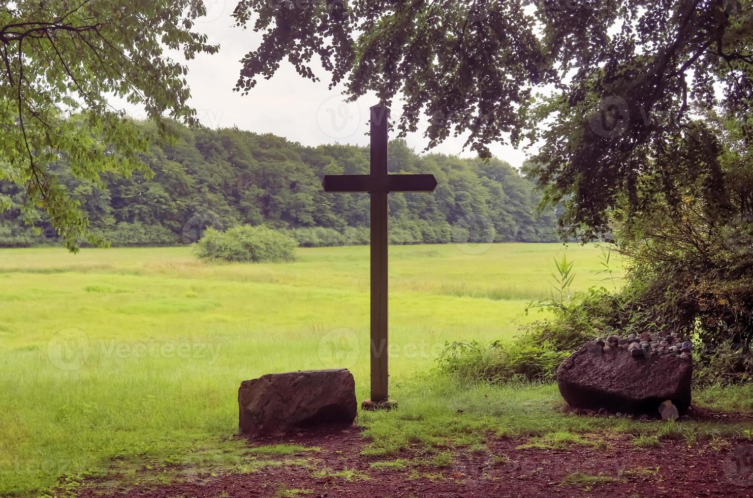 A religious wooden cross in a small forest in europe. photo