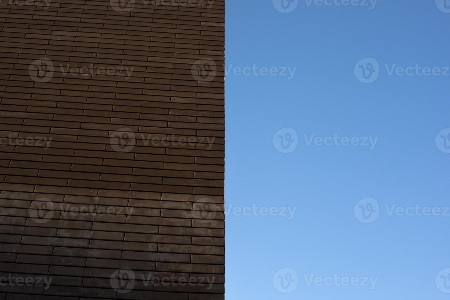 Wall of house is brown. Wall and sky. photo