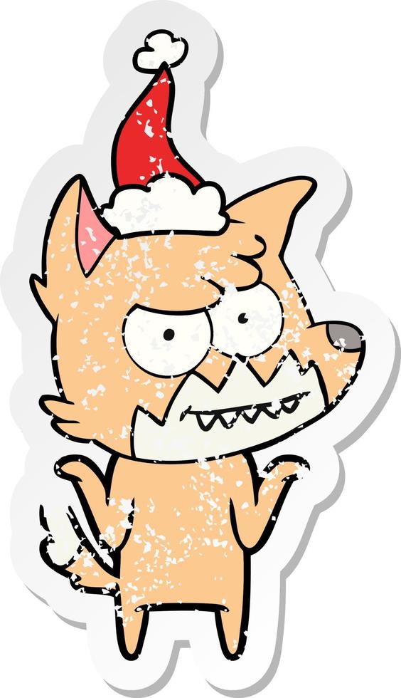 distressed sticker cartoon of a grinning fox wearing santa hat vector