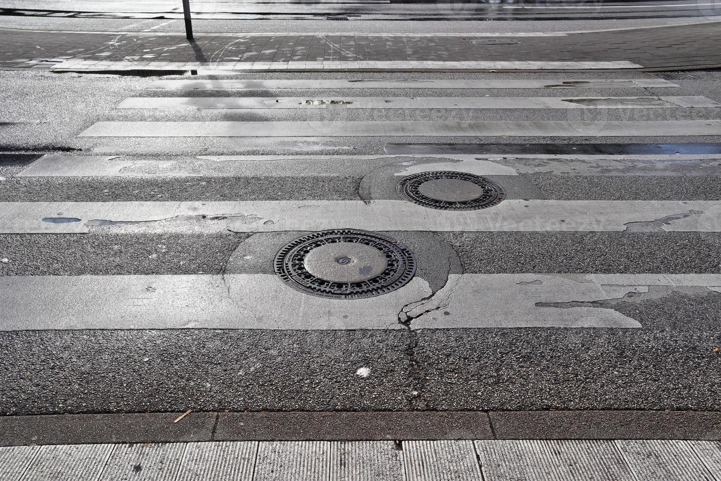 Different signs and marking painted on the ashpalt of streets and roads. photo