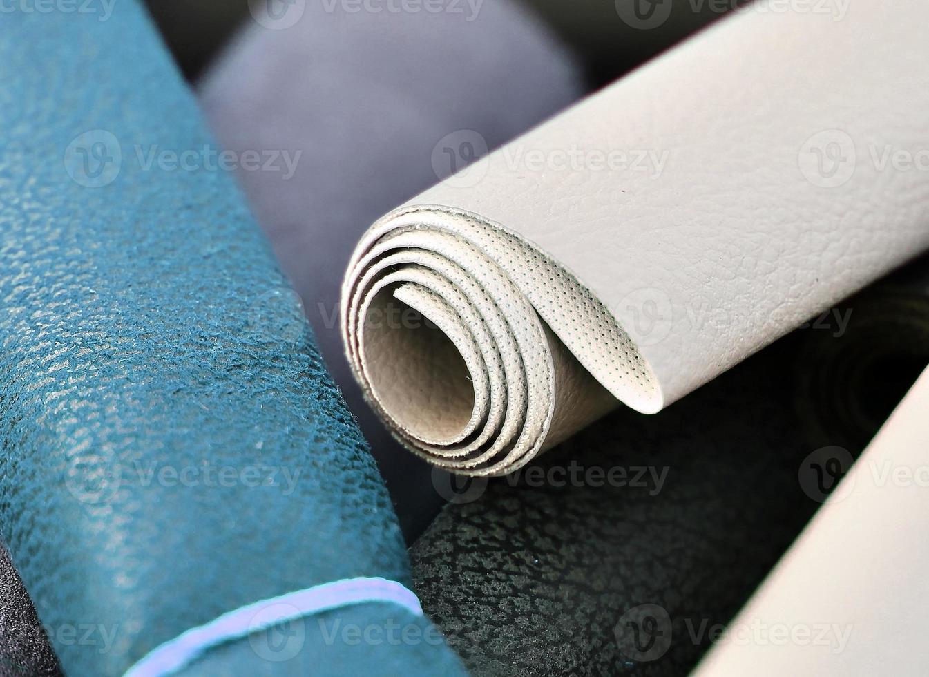 Detailed close up view on samples of cloth and fabrics in different colors found at a fabrics market photo