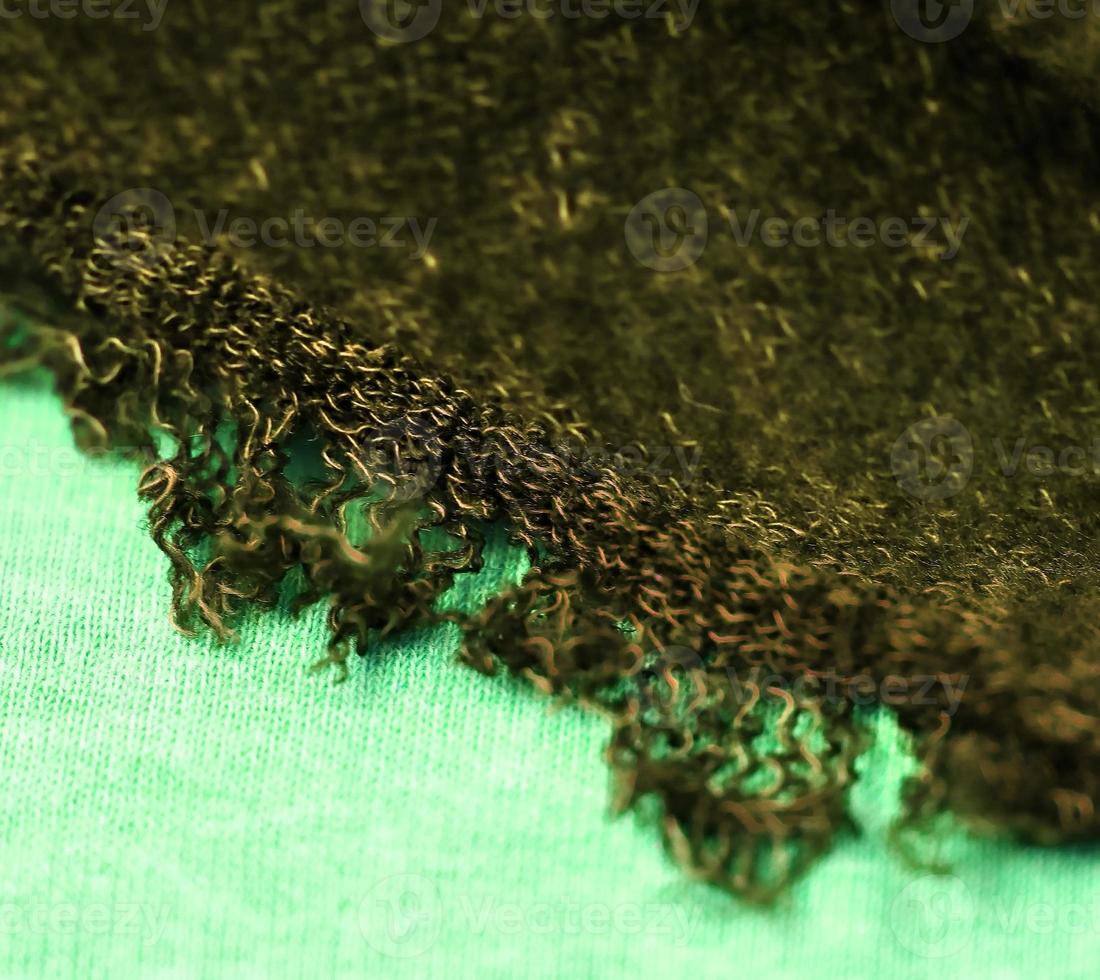 Detailed close up view on samples of cloth and fabrics in different colors found at a fabrics market photo